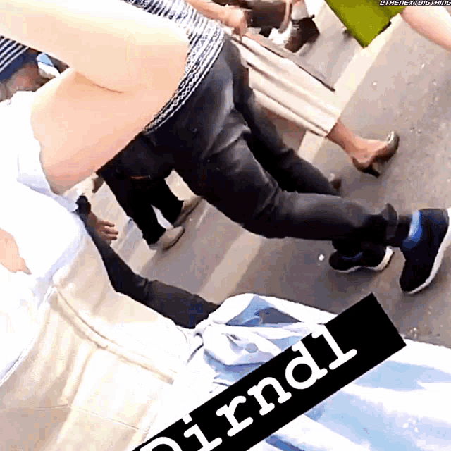 a person is laying on the ground with a sign that says dirndl