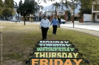 two people walking in front of a sign that says monday through friday