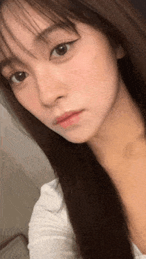 a close up of a woman 's face with her eyes closed