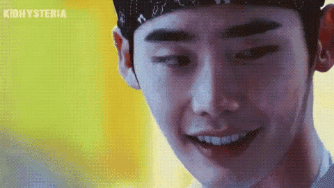 a close up of a man wearing a bandana smiling .