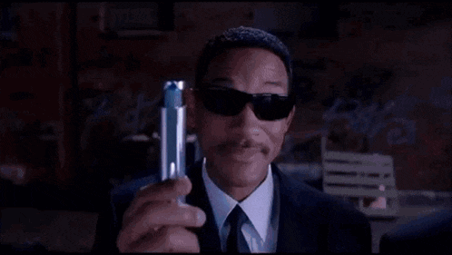 a person is holding a fork in front of a blue light coming out of their head .
