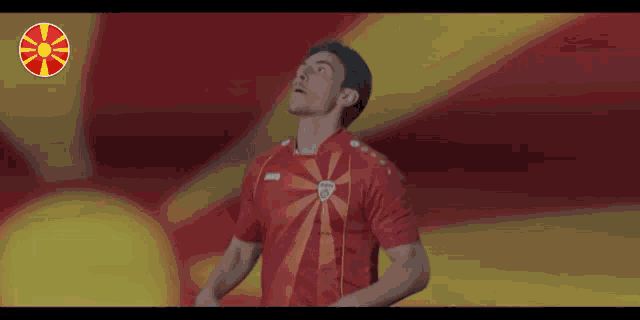 a man wearing a red shirt with jako on it