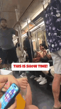 a group of people riding a subway train with a sign that says this is show time