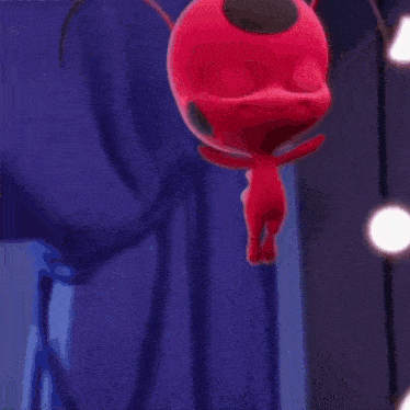 a close up of a pink light coming out of a red object .