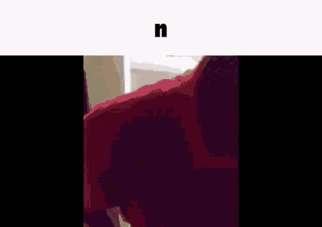 a man in a red shirt is standing in a room next to a door .