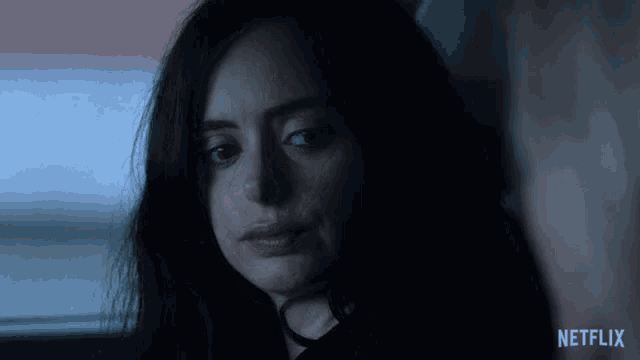 a close up of a woman 's face with the netflix logo visible