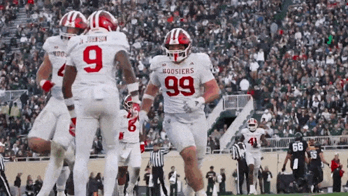 a group of hoosier football players celebrate a touchdown