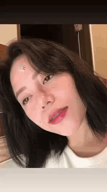a close up of a woman 's face with braces on her teeth .