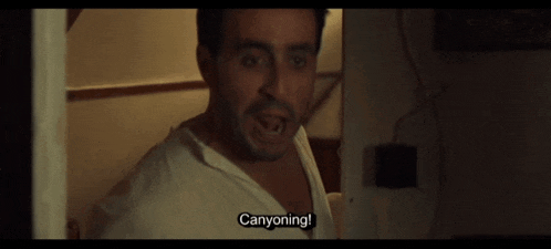 a man in a white shirt says canyoning