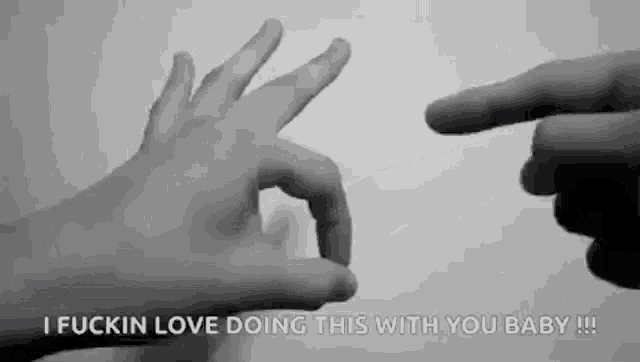 a black and white photo of two hands making a ok sign .
