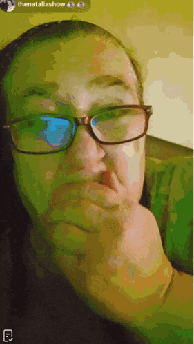 a woman wearing glasses is making a funny face with her hand on her chin ..