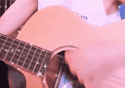 a person is playing an acoustic guitar with a shirt that says a03 on it