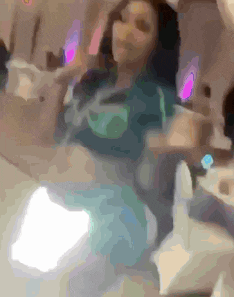 a blurry picture of a woman giving a thumbs up sign