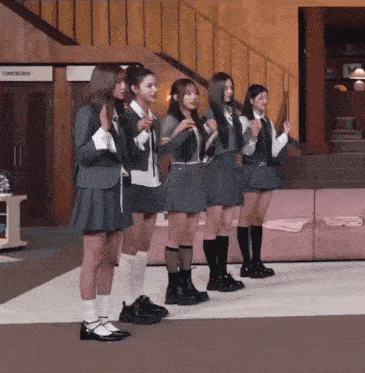a group of girls standing in front of a timebomb sign