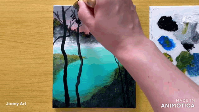 a person is painting a landscape with the words made in animatica below