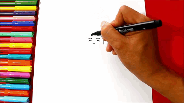 a person is drawing with a faber-castell marker