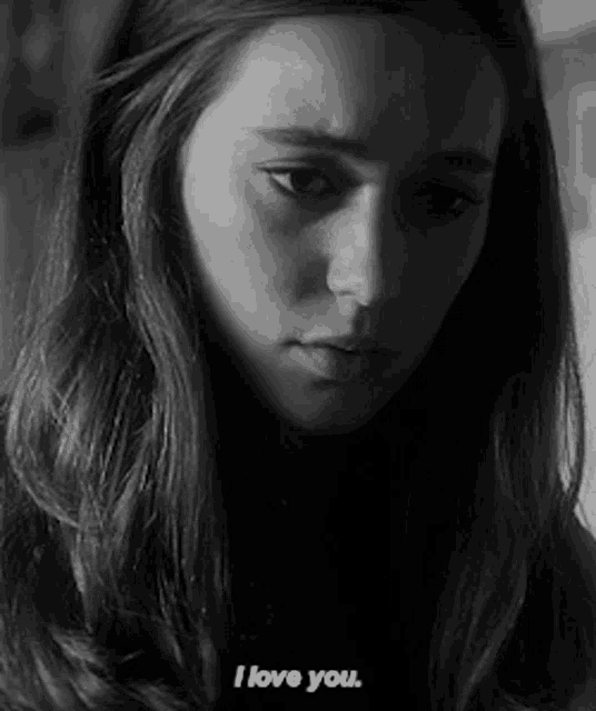 a black and white photo of a woman with the words i love you on her face