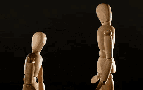 two wooden mannequins are standing next to each other with the words entschuldigung written on the bottom