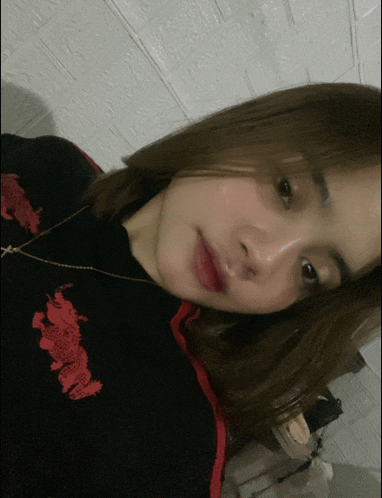 a woman wearing a black shirt with red dragons on the front