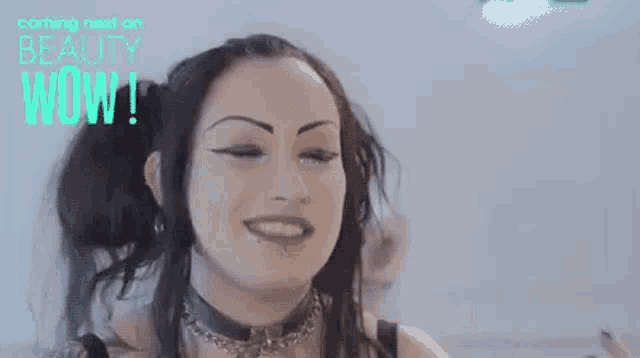 a woman with long black hair is smiling and wearing a choker necklace .