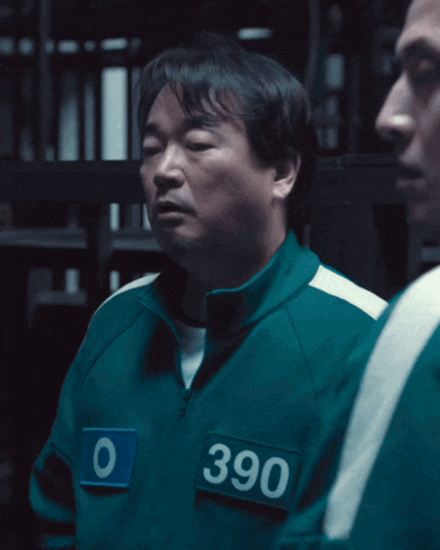 a man in a green jacket has the number 390 on his chest
