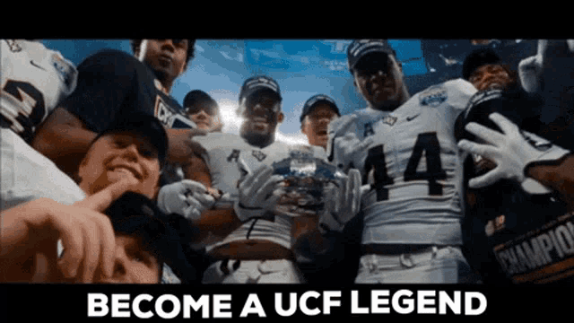 a group of football players holding a trophy with the words " become a ucf legend " above them
