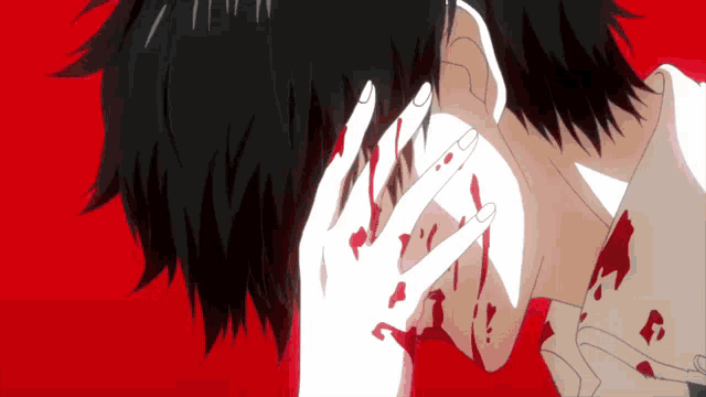 a man with blood on his face is covering his face with his hands
