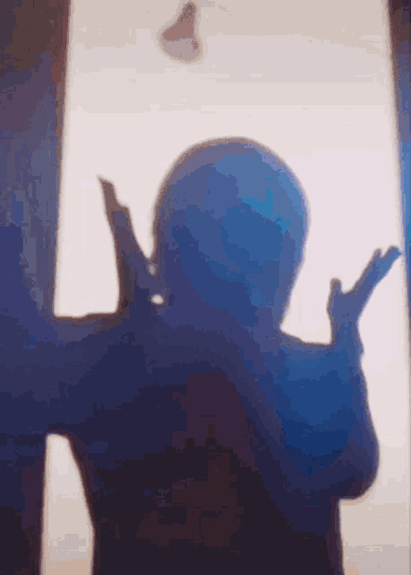 a shadow of a person making a peace sign