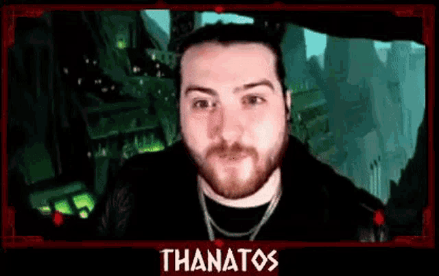 a man with a beard is making a funny face in front of a green screen .
