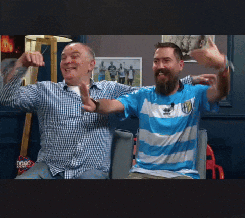 two men are sitting next to each other and one of them is wearing a shirt that says ' parma ' on it
