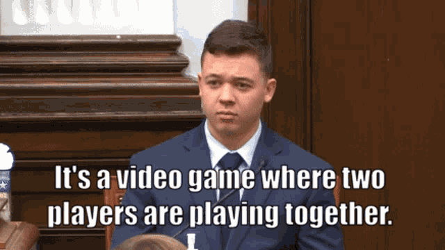 a man in a suit and tie says it 's a video game where two players are playing