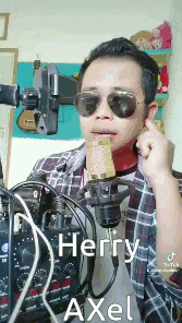 a man wearing sunglasses is singing into a microphone with the name herry axel written below him
