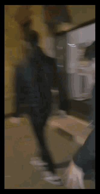a blurry photo of two people walking down the street