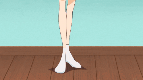 a woman in a yellow sweater and brown shorts stands on a blue floor