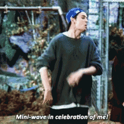 a man in a baseball cap says " mini wave in celebration of me "