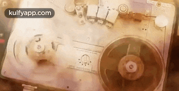 a close up of a tape recorder playing a record on a table .
