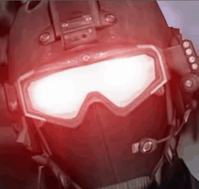 a close up of a person wearing a helmet and goggles with red lights coming out of them .