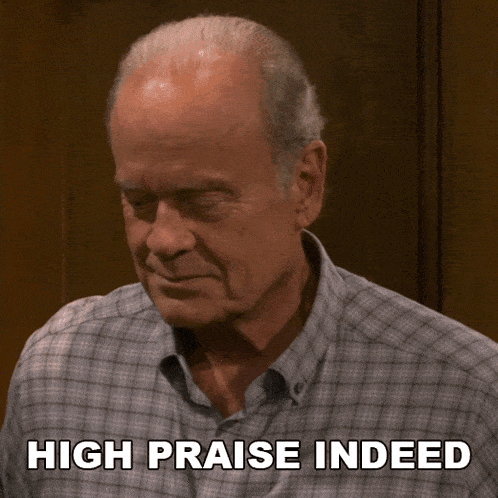 a man in a plaid shirt with the words high praise indeed written below him