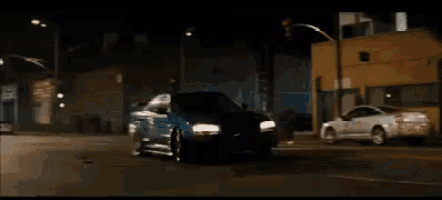 a blue car is driving down a street with the words bukan cuma bajai yg ngeles written above it
