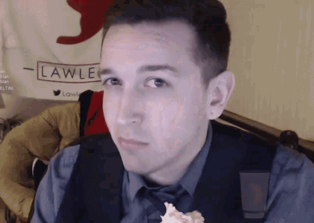 a man is eating a piece of cake in front of a lawle flag