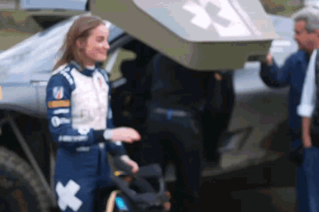 a woman in a racing suit with a white cross on her chest
