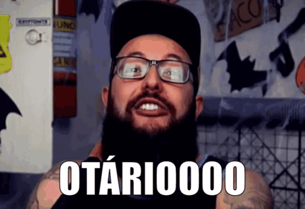 a bearded man wearing glasses and a hat says otari00000