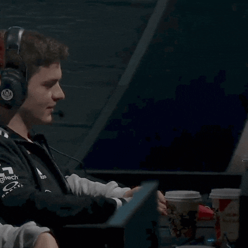 a man wearing headphones with the letter g on the front of his shirt
