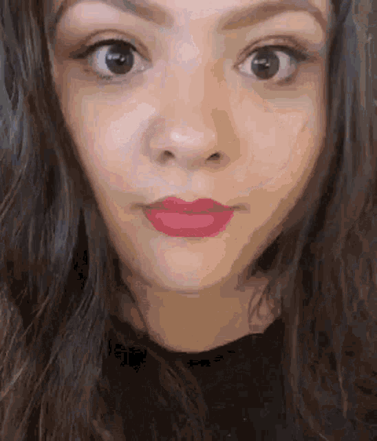 a close up of a woman 's face with red lipstick on