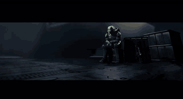 a video game character is sitting in the dark
