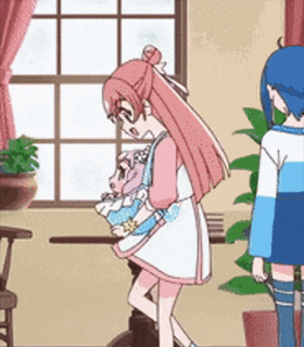 a girl in a pink dress is standing next to a boy in a blue shirt in a room holding a doll .