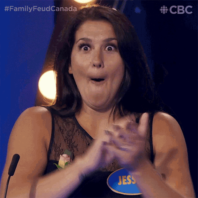 a woman with a name tag that says jess applauds