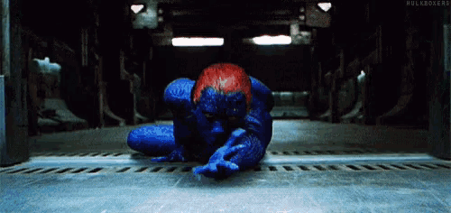 a person in a blue and red superhero costume is laying on the floor .