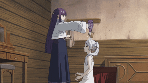 a girl with purple hair is pouring something into another girl 's hair