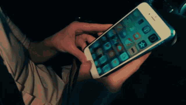 a person holding a cell phone with the number 1 on the screen